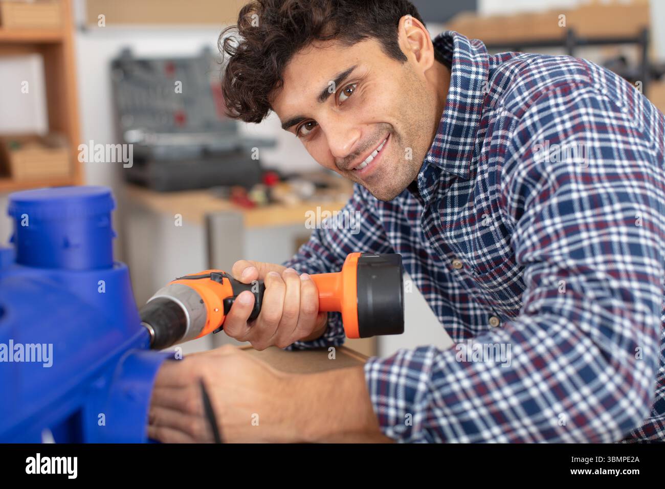 handsome young man holding drilling machine Stock Photo