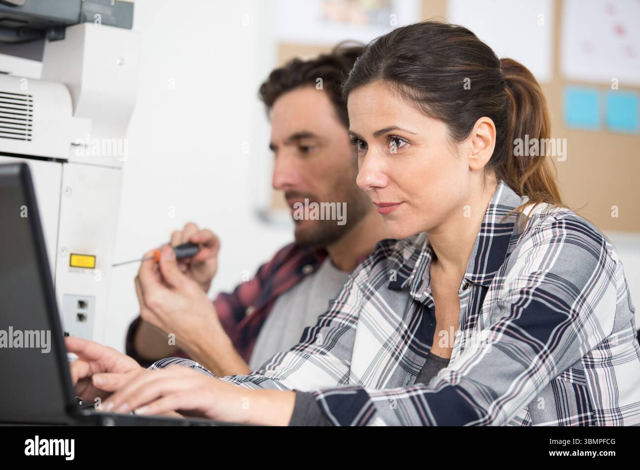woman calibrating printer while working in nice printing office Stock Photo