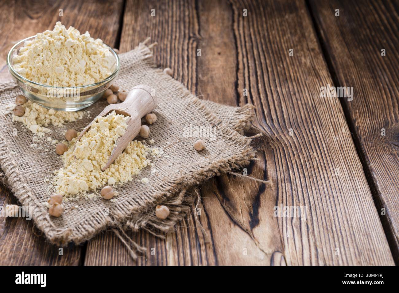 Chick Pea Flour on dark rustic background (close-up shot) Stock Photo
