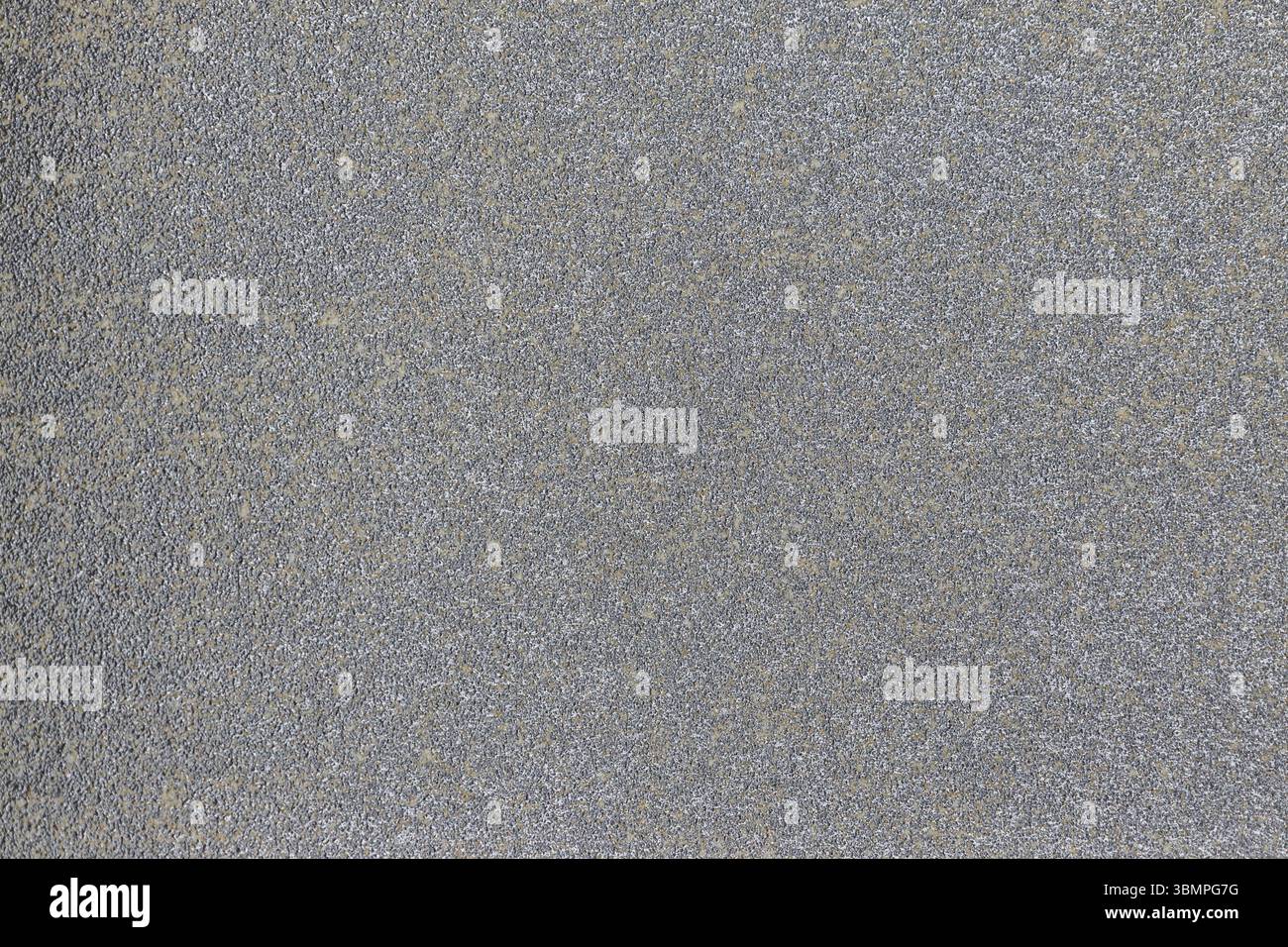 Gray asphalt surface with a rough texture and visible aggregate, ideal for design projects, backgrounds, and urban infrastructure visuals Stock Photo