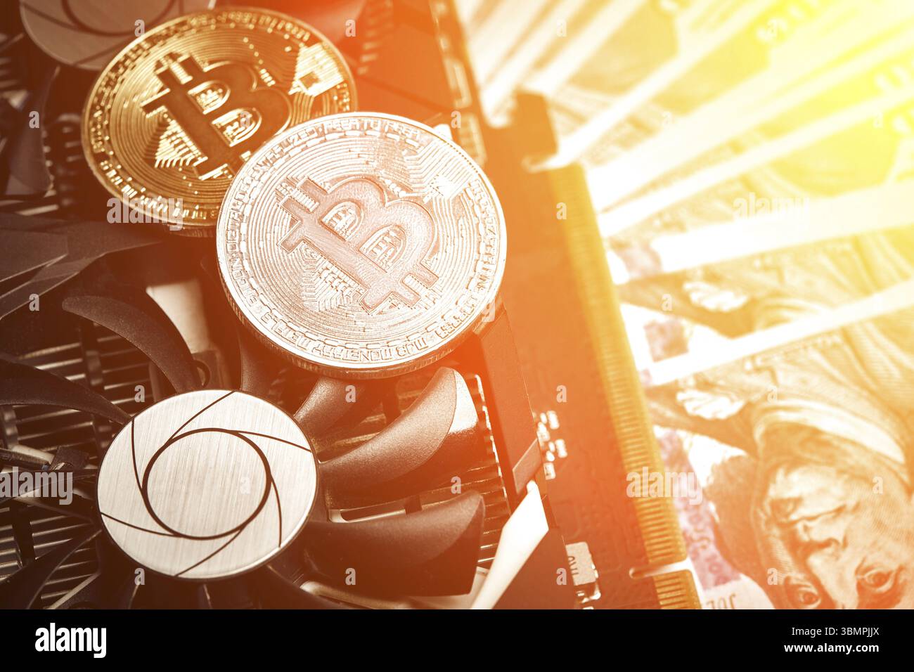 The coin of bitcoin lies on video card with dollars. Exchange bitcoin cash for a dollar. Flat lay. Top view. Still life. Sun flare Stock Photo