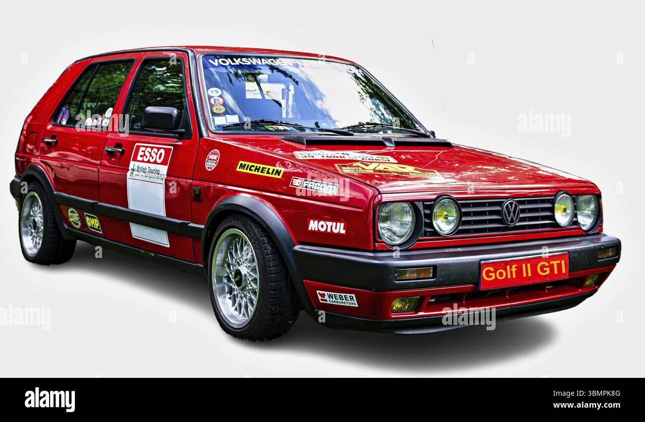 Customized red Volkswagen Golf II GTI posing on a white background, showing Esso, Michelin, Motul, Weber and Facom stickers Stock Photo