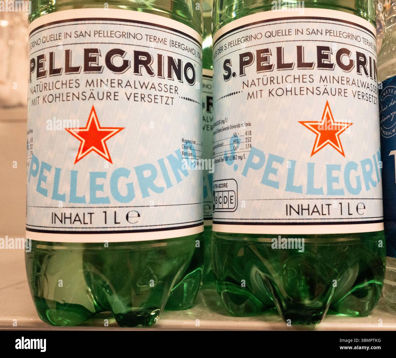 Altshausen S.Pellegrino Mineralwasserflaschen im Regal Zwei grüne 1-Liter-PET-Flaschen des italienischen Mineralwassers S.Pellegrino stehen nebeneinander im Verkaufsregal eines Supermarkts in Altshausen. Die Etiketten tragen die typischen Merkmale der Marke mit dem roten Stern und der Aufschrift natürliches Mineralwasser mit Kohlensäure versetzt. Die Aufnahme zeigt die Nahansicht der Flaschen im Alltag des Lebensmitteleinzelhandels. Eibner-Pressefoto/Eky Eibner. *** Altshausen S Pellegrino mineral water bottles on the shelf Two green 1-liter PET bottles of the Italian mineral water S Pellegrin Stock Photo