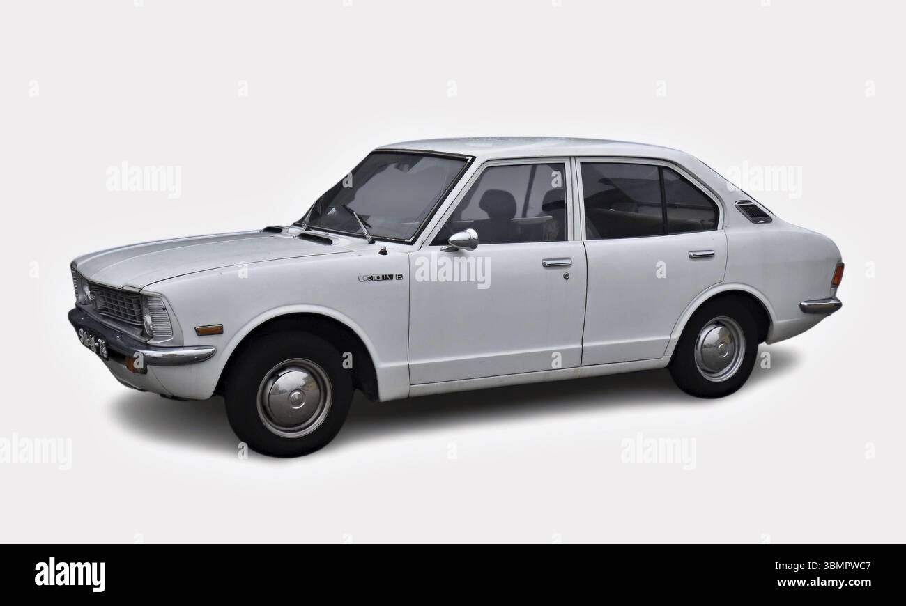 Classic white Toyota Corolla from the 70s parked against white background Stock Photo