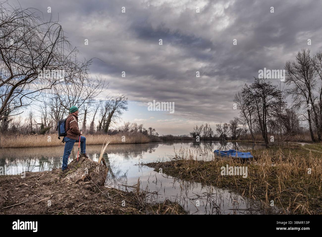 Hiker resting on river bank. Hike and people concept, travel, tourism Stock Photo