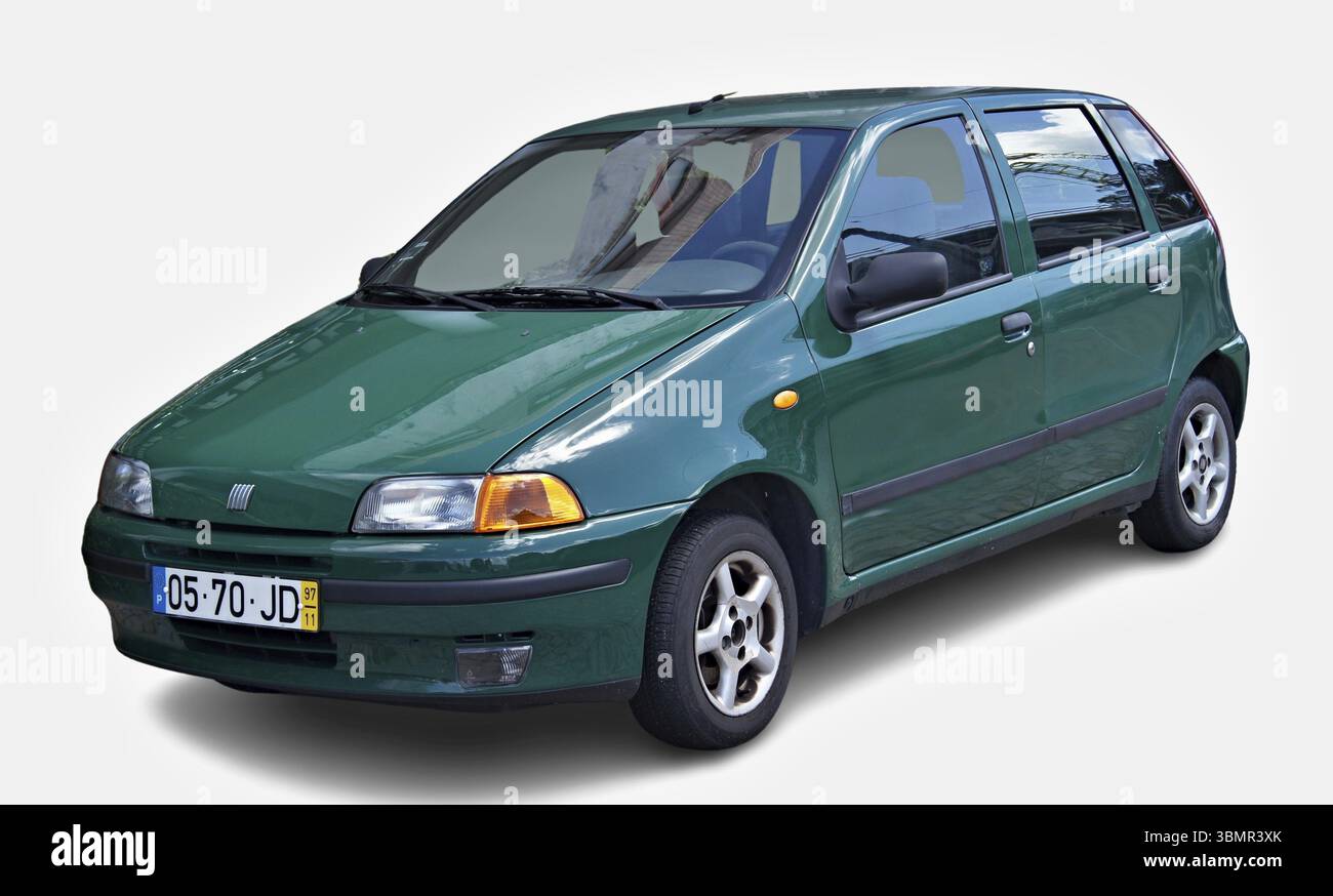 green-fiat-punto-parked-showing-its-front-and-side-on-a-white