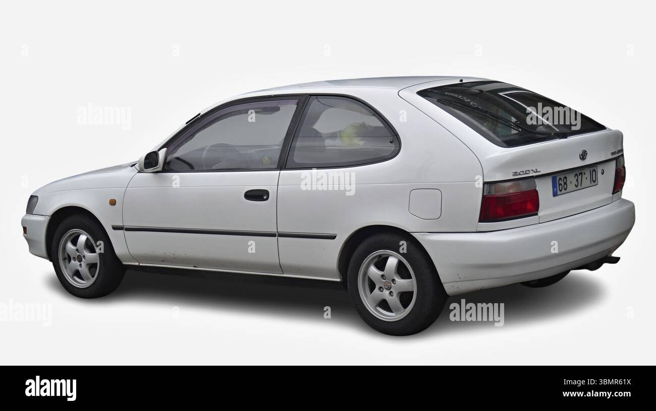 White Toyota Corolla E100 series, 3-door hatchback parked on white background, rear view Stock Photo