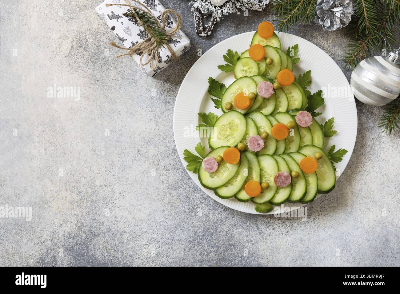 Christmas appetizer. Christmas tree from a salad olivier on a gray stone background. View from above. Copy space Stock Photo