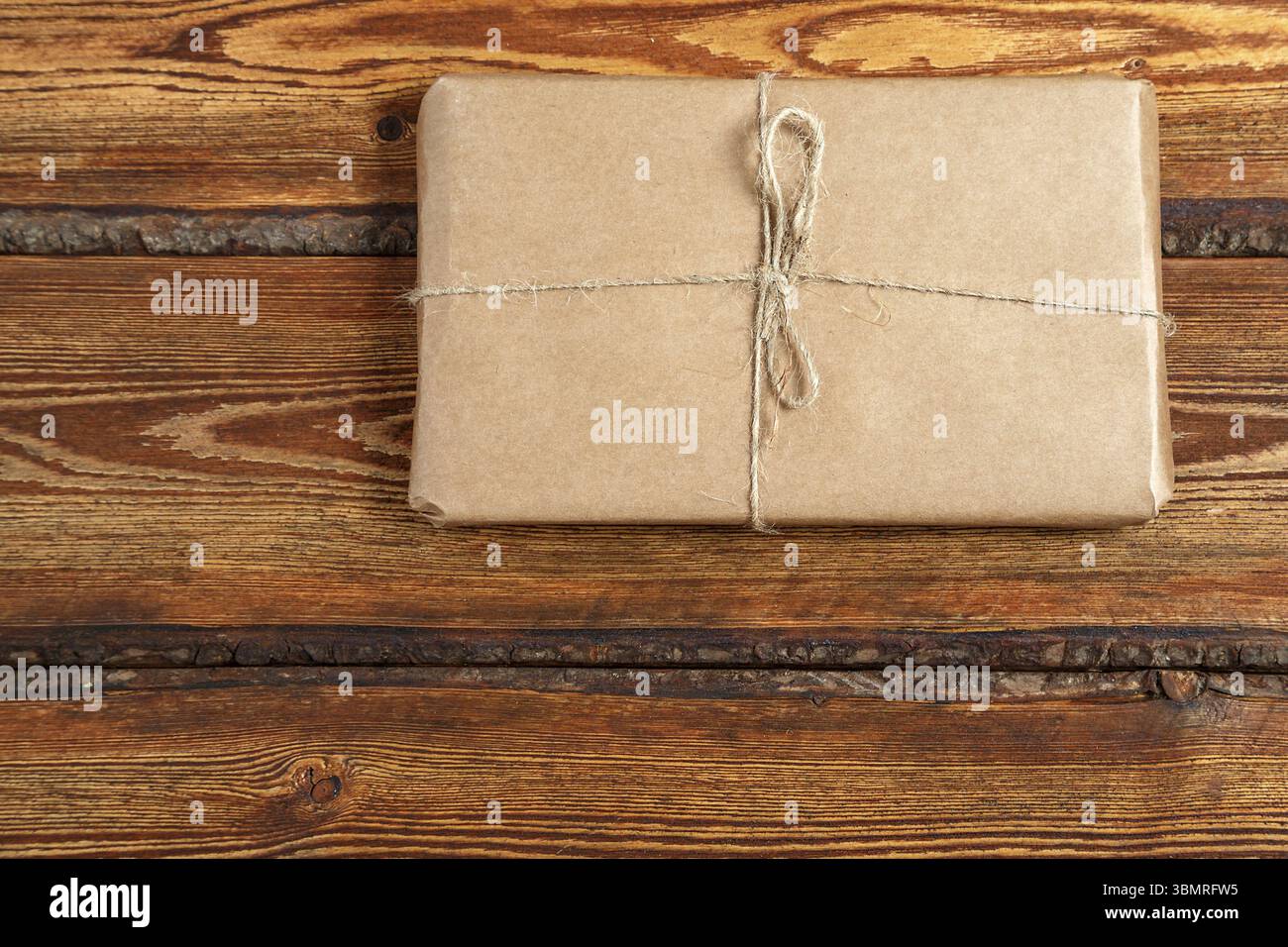 Gift Packed in eco-friendly biodegradable cardboard on dark old wooden background with blank space for text. top view. flat lay Stock Photo