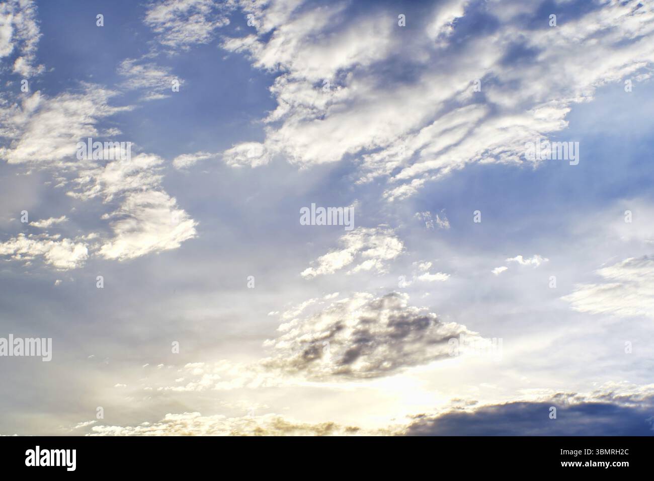 Sunset clouds with sun setting down. Beautiful evening sky with clouds background Stock Photo
