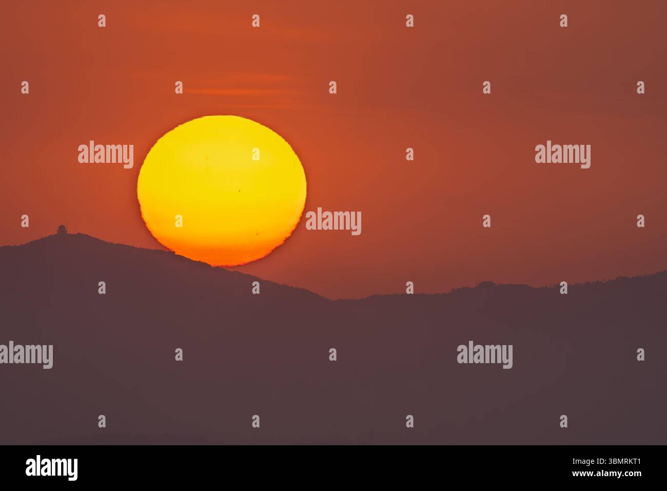Sunset with a big sun and sunspots Stock Photo