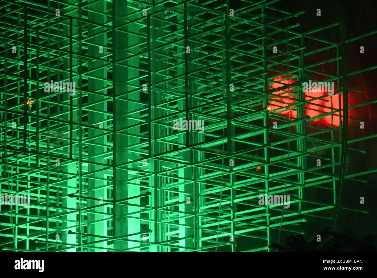 Glowing geometric light installation at night Stock Photo