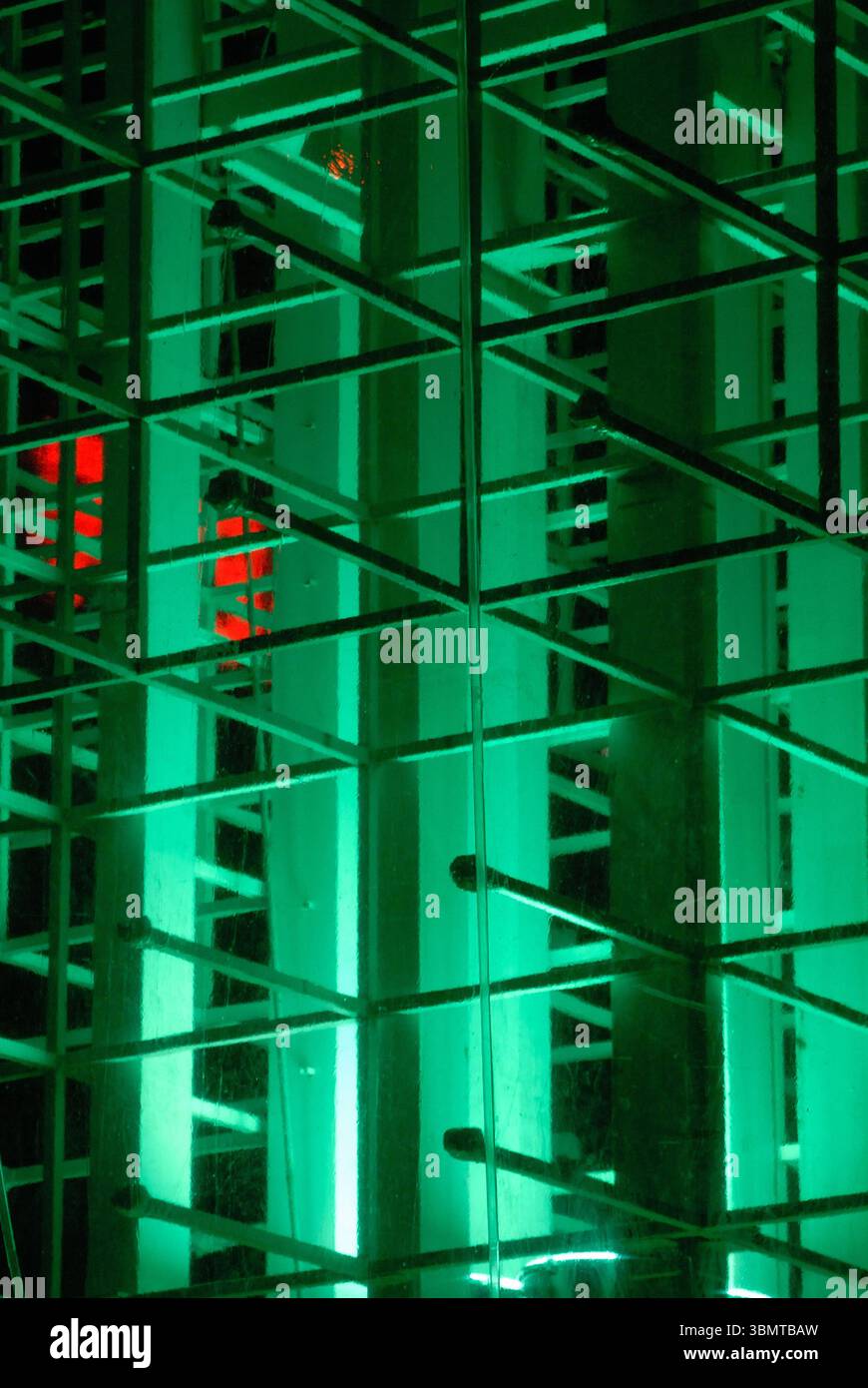 Glowing geometric light installation at night Stock Photo