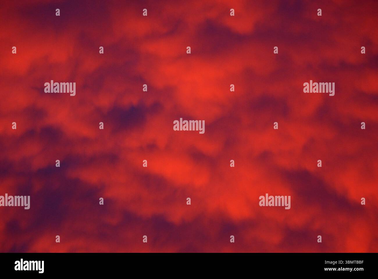 Abstract sky with glowing pink and purple clouds at sunset or sunrise ...