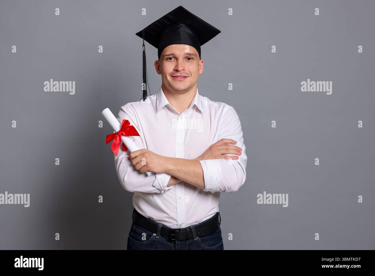 Happy student with diploma after graduation on grey background Stock ...