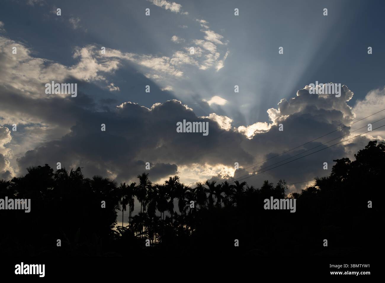 Sunbeams Bursting Through Clouds at Sunset Stock Photo