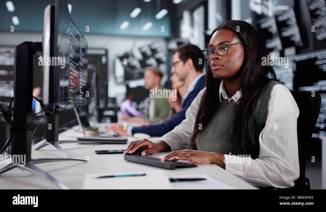 Young African American Coder Explaining New Software Development To Diverse Group. Stock Photo