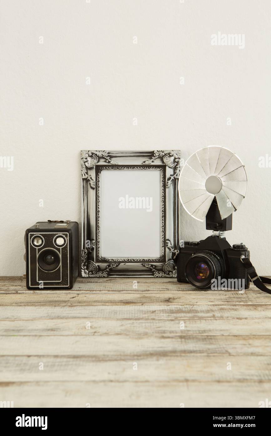 Photo frame, speaker and camera on table Stock Photo