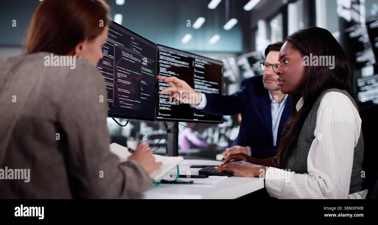 Innovative African Programmer Collaborating With Diverse Team In Cyber Office. Stock Photo