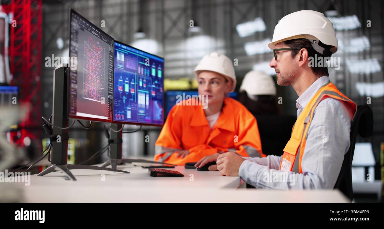 Young African American Engineer Using SCADA Software On Desktop Computer Stock Photo