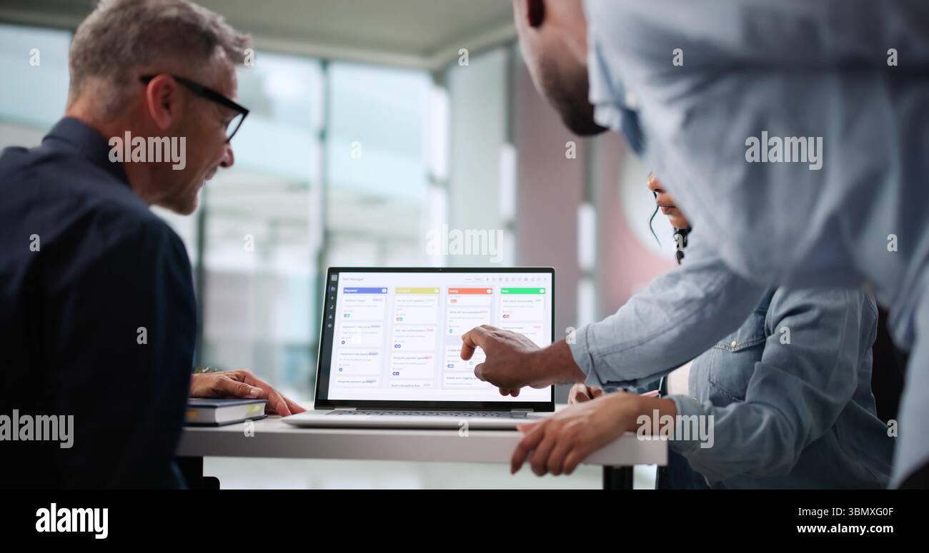Multicultural Project Team Collaborates Using Various Management Techniques And Software. Stock Photo