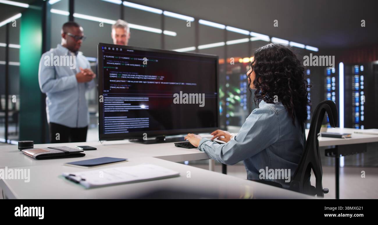 Multiracial Programming Team Working Together To Develop Innovative Software Solutions. Stock Photo