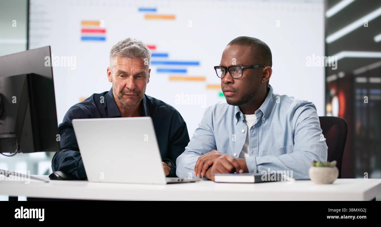 Multiracial Office Team Using Gantt And Kanban Boards For Efficiency. Stock Photo