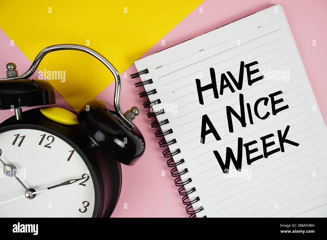 Have A Nice Week text written on notepad with alarm clock on pink ...