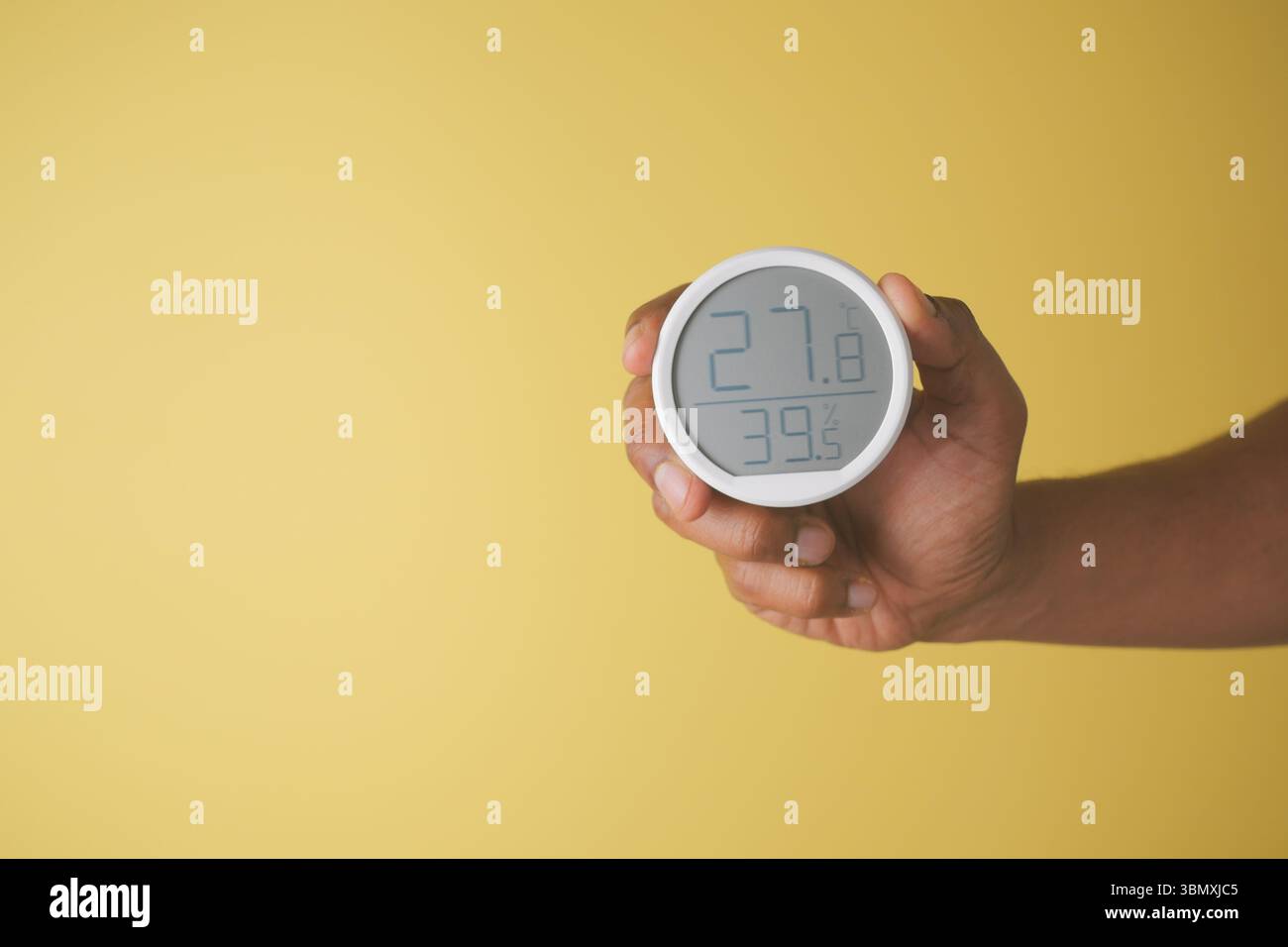 Humidity monitor on a yellow background Stock Photo - Alamy