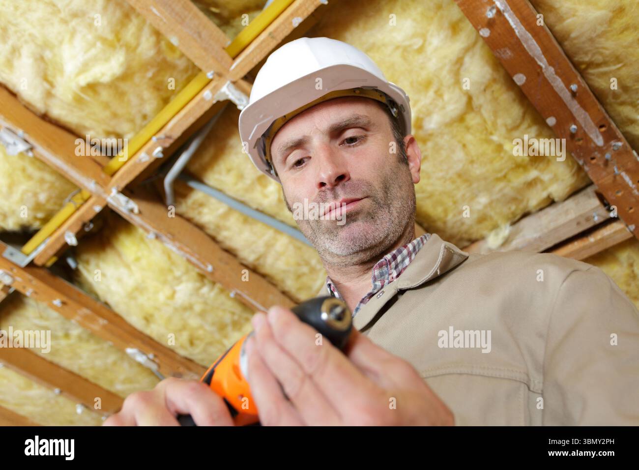 man drilling in construction site Stock Photo