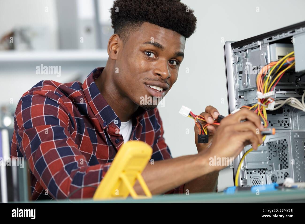 male technician working on a broke pc Stock Photo