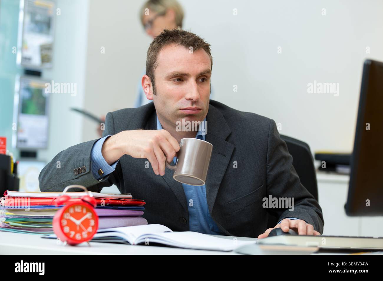 man in black tshirt sit in front of notebook waiting Stock Photo