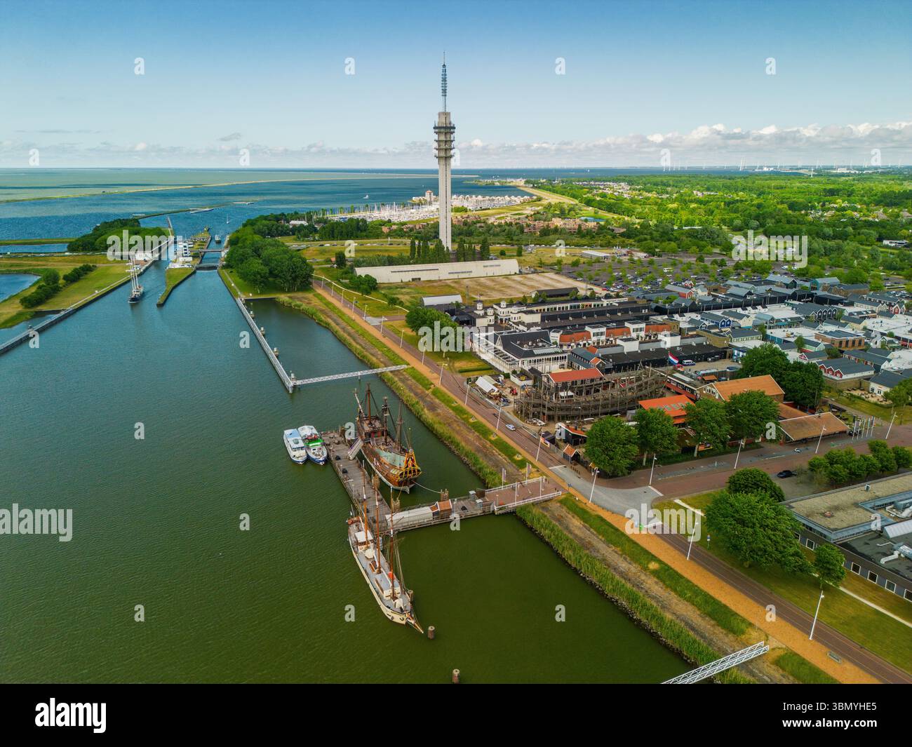 An aerial view of a coastal town with a harbor, colorful buildings, a ...