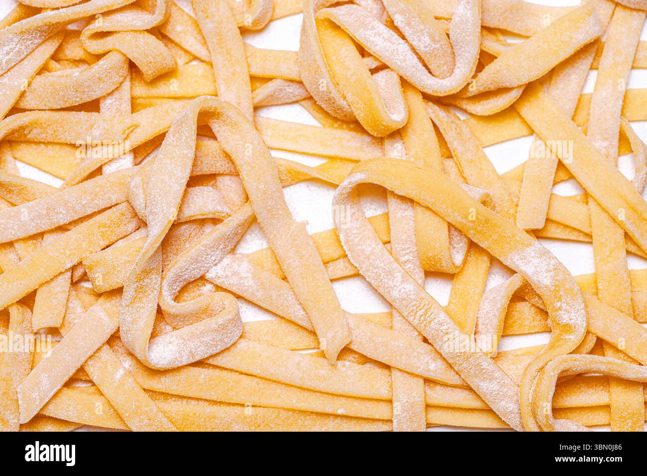 Hard Spaghetti Handmade raw pasta, spaghetti on a white table. Background with raw ...