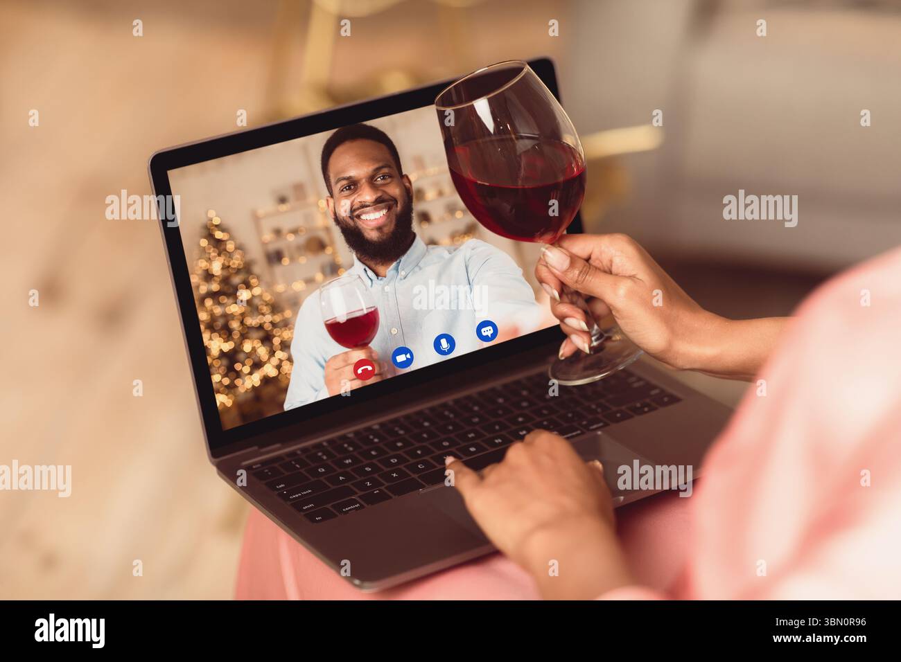 Black couple having online date, drinking wine Stock Photo