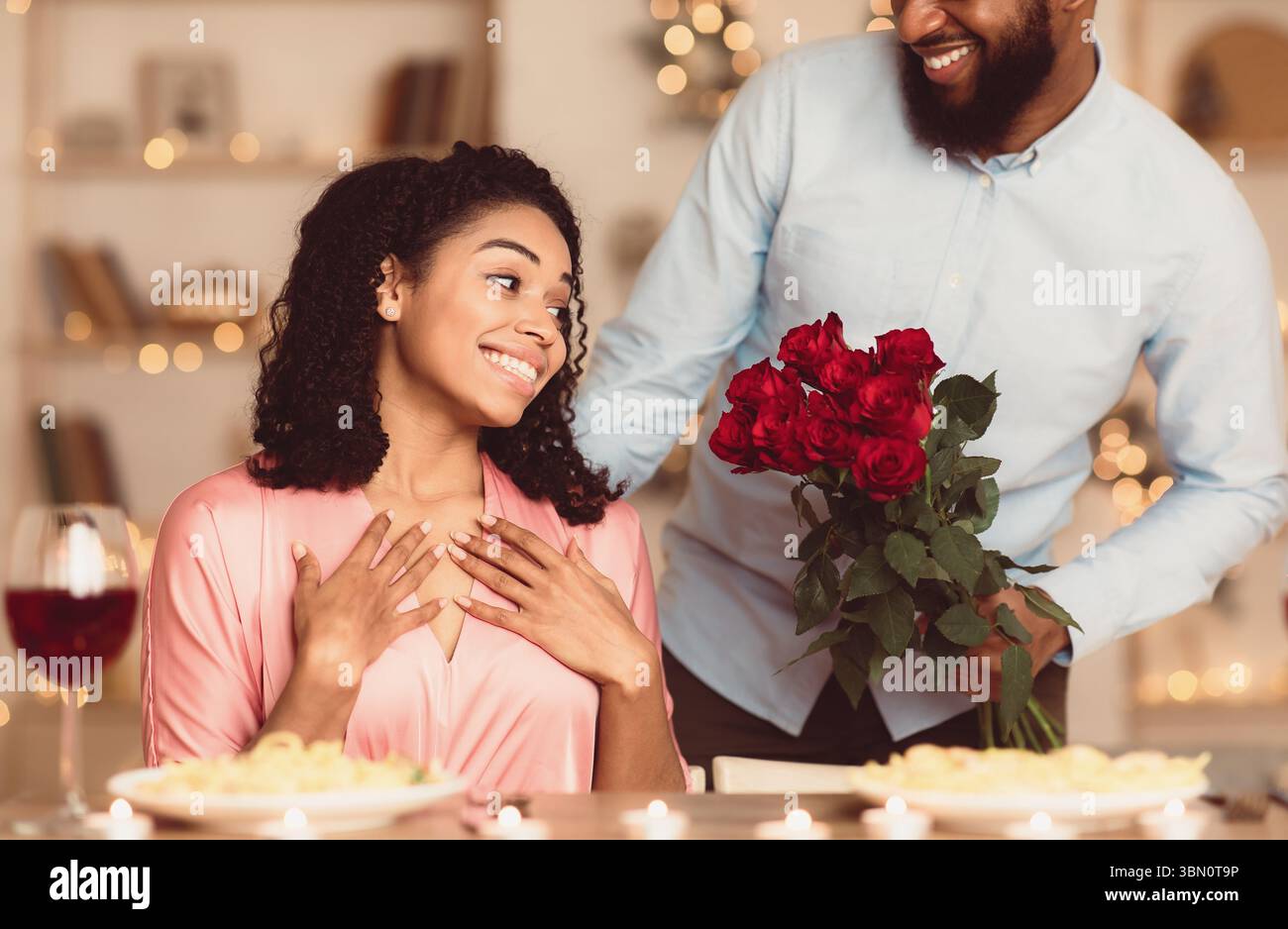 Had Giving Red Roses Young black man giving red roses to excited woman Stock Photo - Alamy