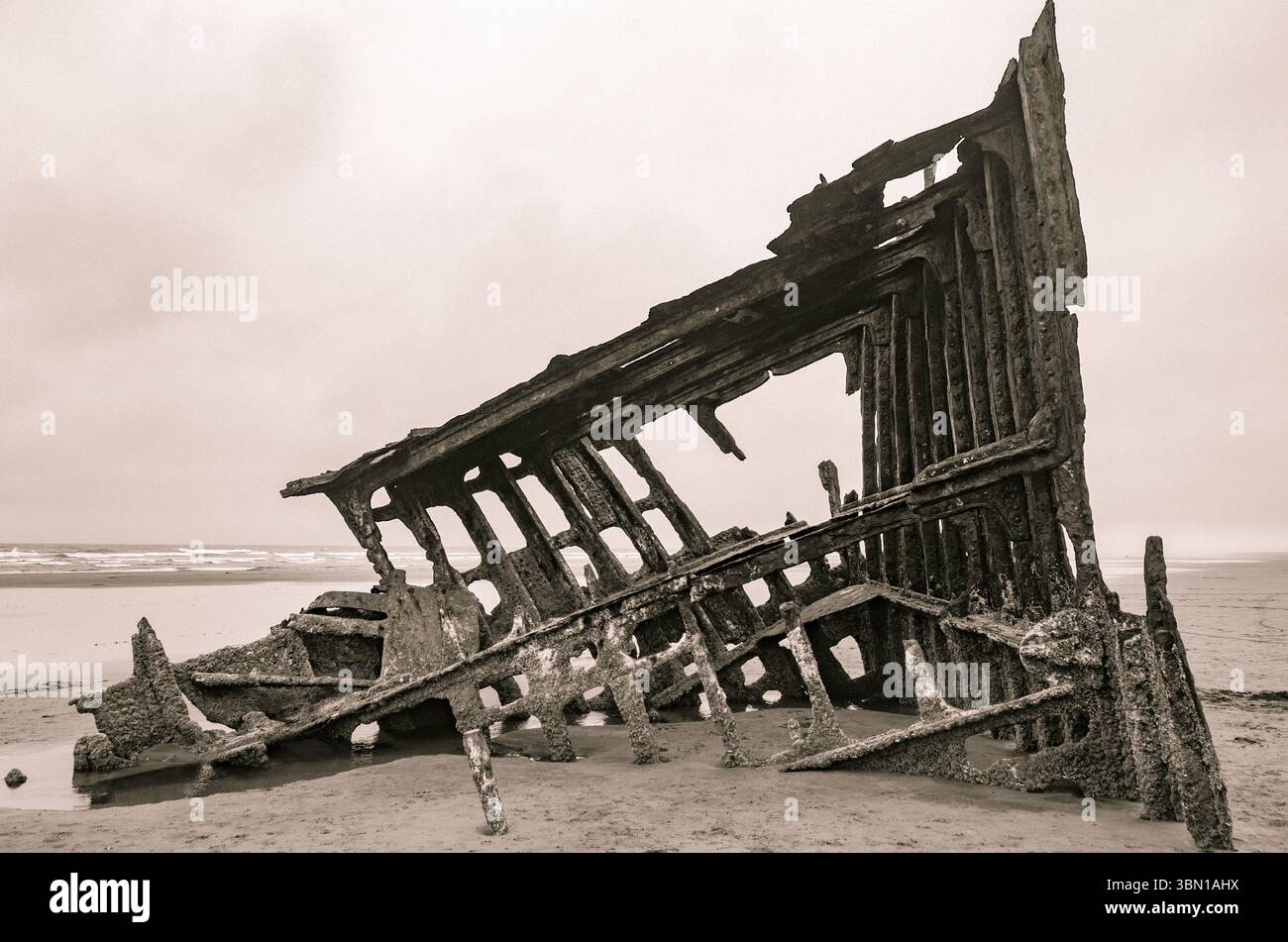 Black and white image of the wreck of the Peter Iredale at Fort Stevens State Park in Oregon, a long time popular tourist attraction. Stock Photo