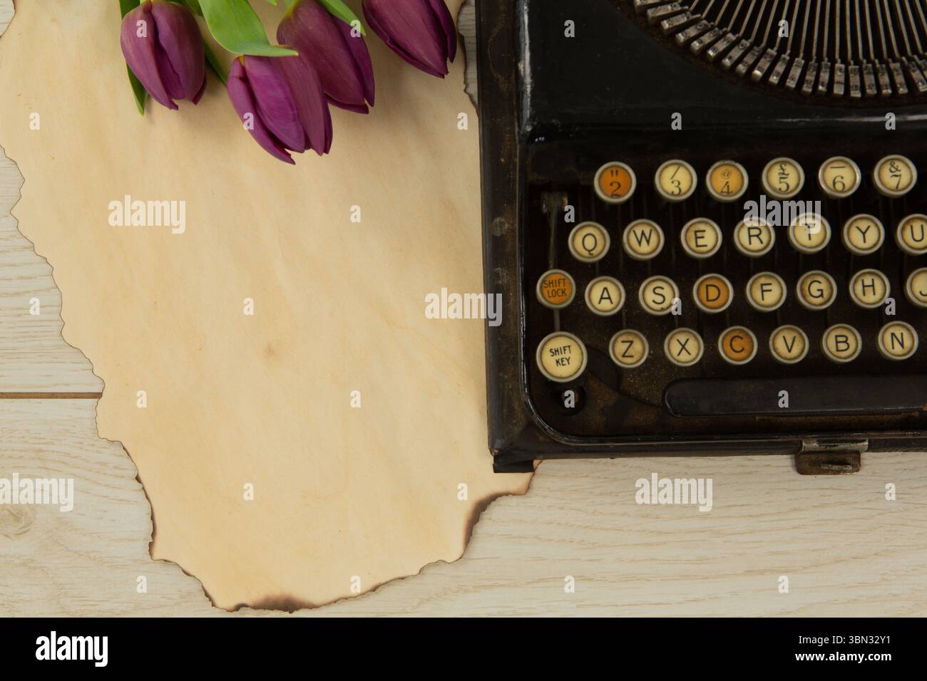 Typewriter and flowers on table Stock Photo