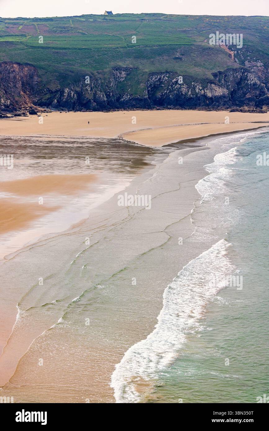 Sandy beach with waves rolling in Stock Photo