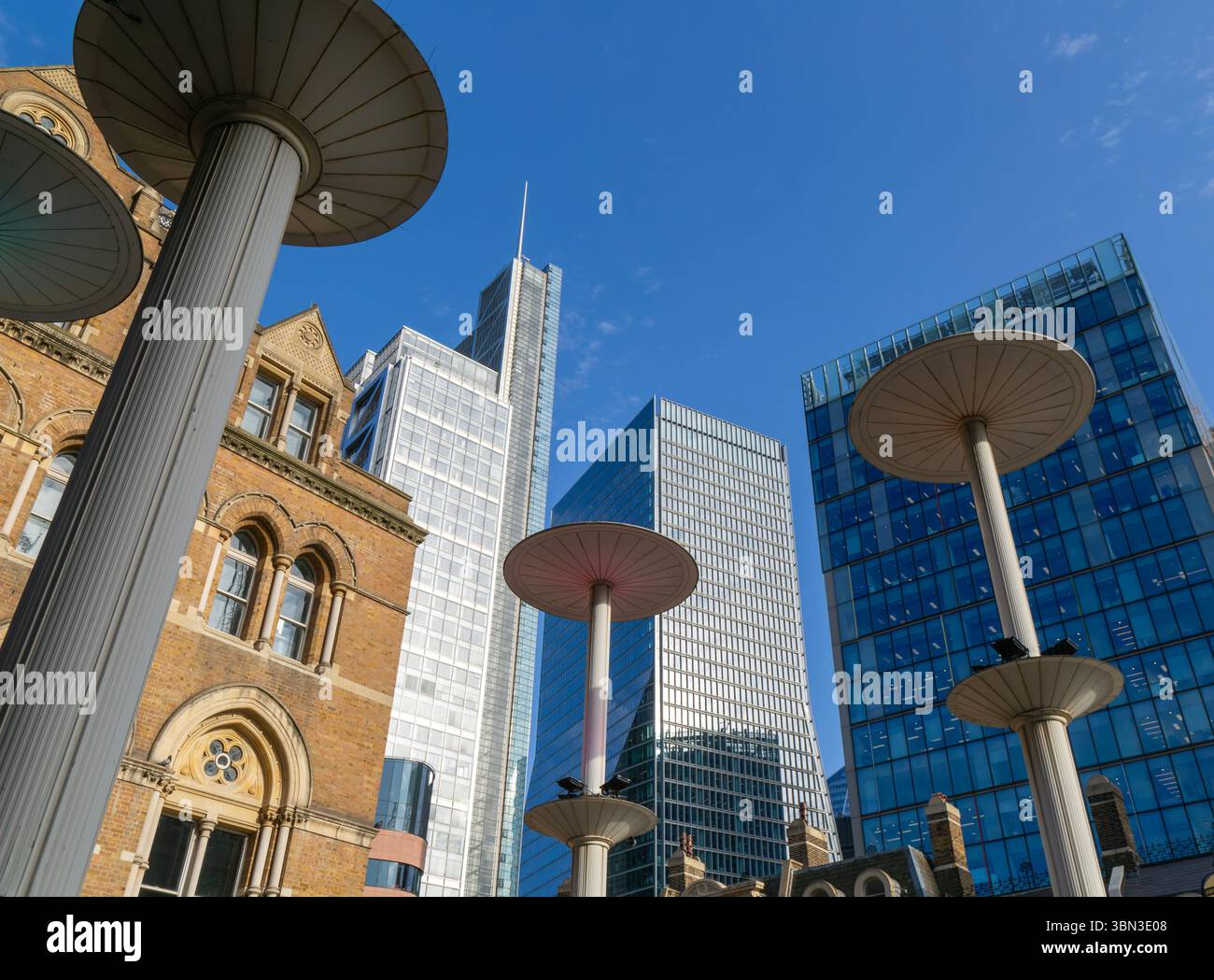 Looking up at office blocks in blue sky from forecourt of Liverpool Street  station, London, England, UK Stock Photo