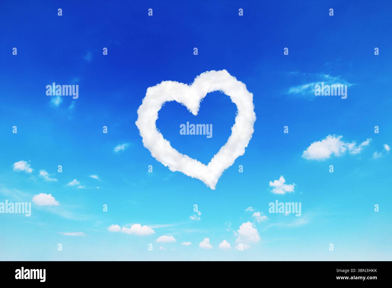 it is single white heart shaped cloud on blue sky. Stock Photo