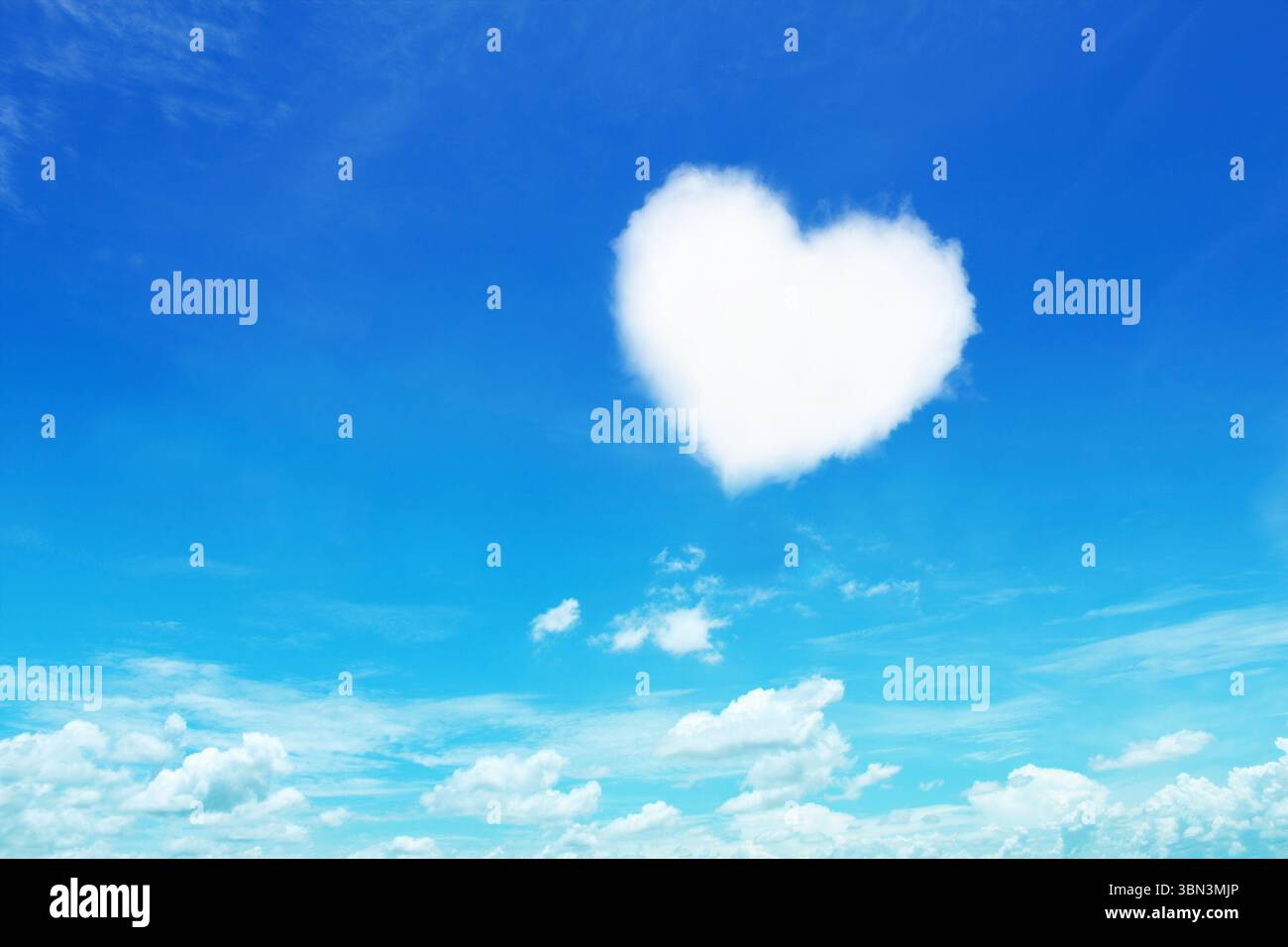 it is one white heart shaped cloud on blue sky. Stock Photo