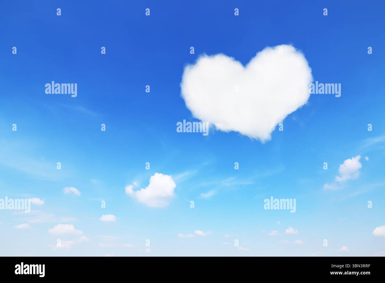 it is one white heart shaped cloud on blue sky. Stock Photo