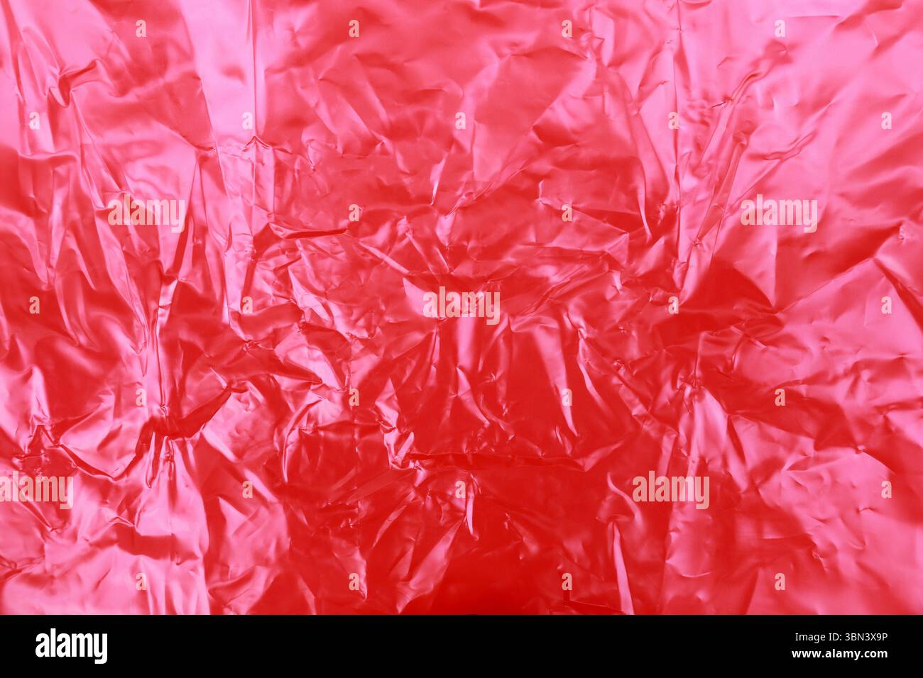 red wrinkled plastic texture background. Stock Photo