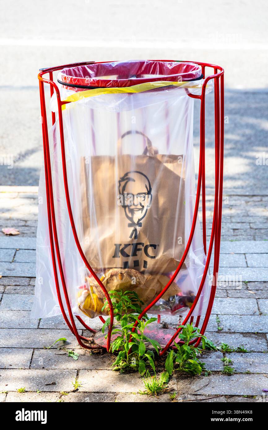 KFC paper bag in a transparent garbage can Stock Photo