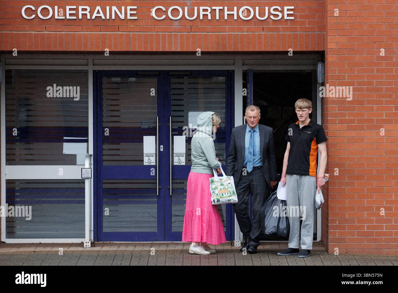 Issac Adams (right) leaves Coleraine Magistrates' Court with his parents, where he was charged in connection to an incident in which slurry was sprayed in Ballymena hours before the town hosted its first Pride parade. Picture date: Monday June 30, 2025. Stock Photo