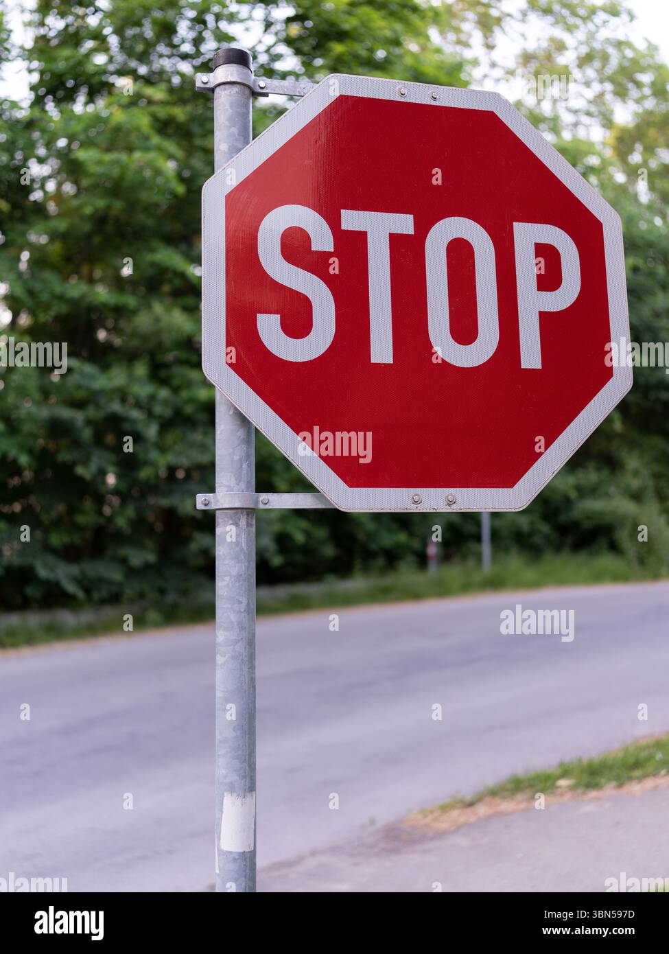 Stop Sign, landscape. Traffic stop sign on a pole next to the road ...