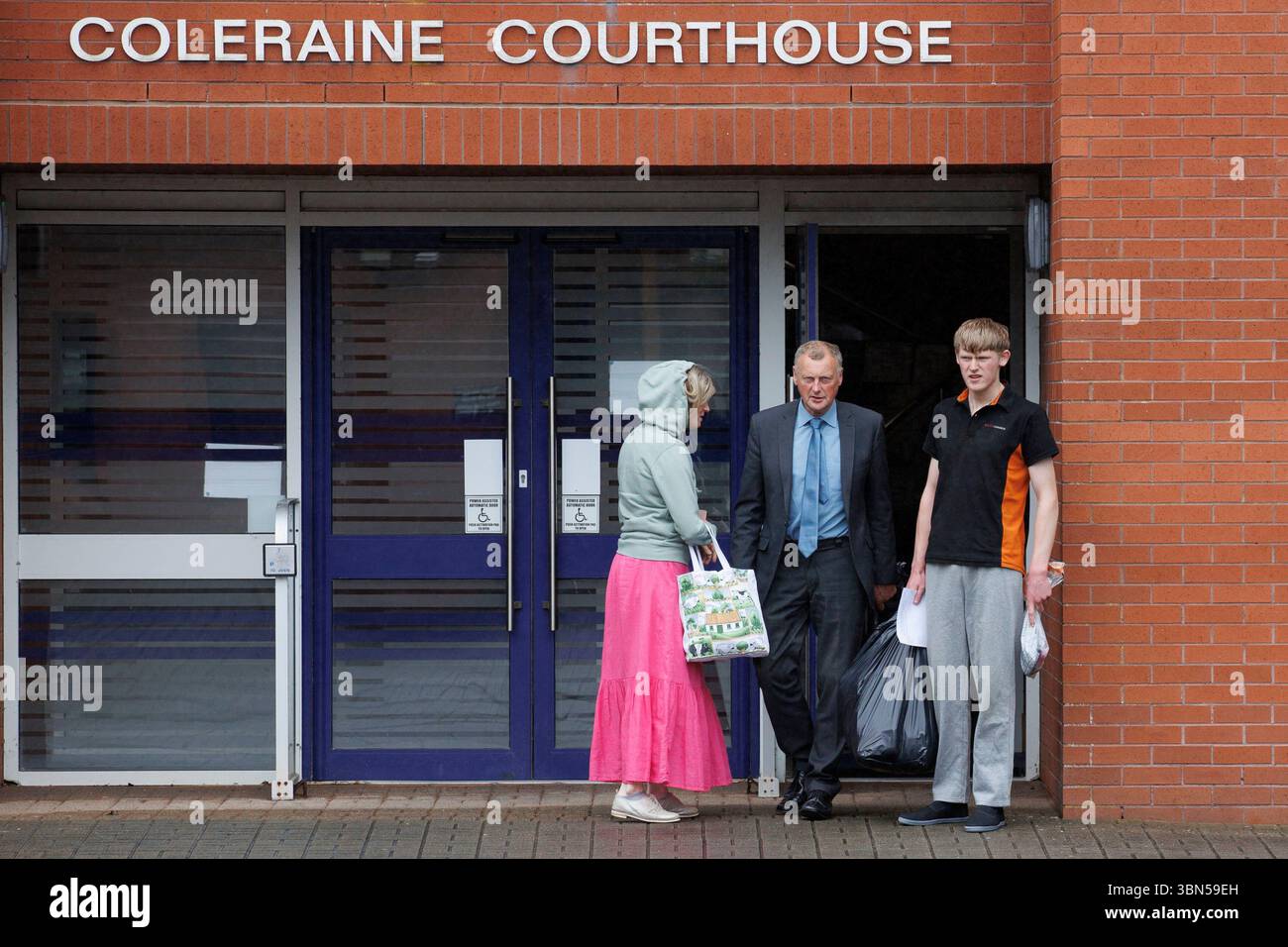 RETRANSMITTING CORRECTING NAME FROM ISSAC TO ISAAC Isaac Adams (right) leaves Coleraine Magistrates' Court with his parents, where he was charged in connection to an incident in which slurry was sprayed in Ballymena hours before the town hosted its first Pride parade. Picture date: Monday June 30, 2025. Stock Photo