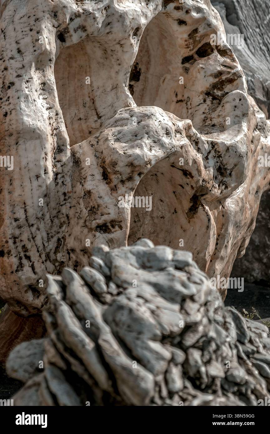 A stone formation with holes and a rough surface. The light-colored ...