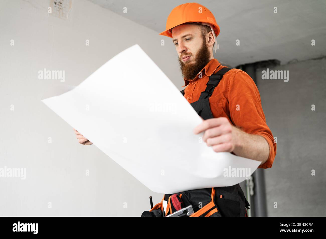 Bearded engineer builder with blueprints. Architect at construction site. Construction engineer with papers. Copy space Stock Photo